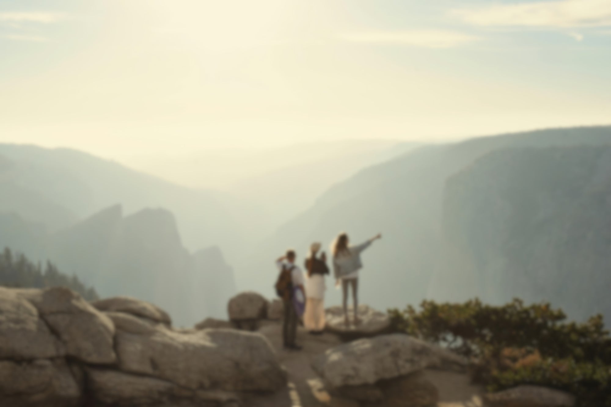 Group of people standing on a mountain top with a scenic view